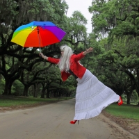 woman-jumping-with-colorful-umbrella